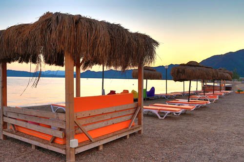 Beach cabanas at sunset